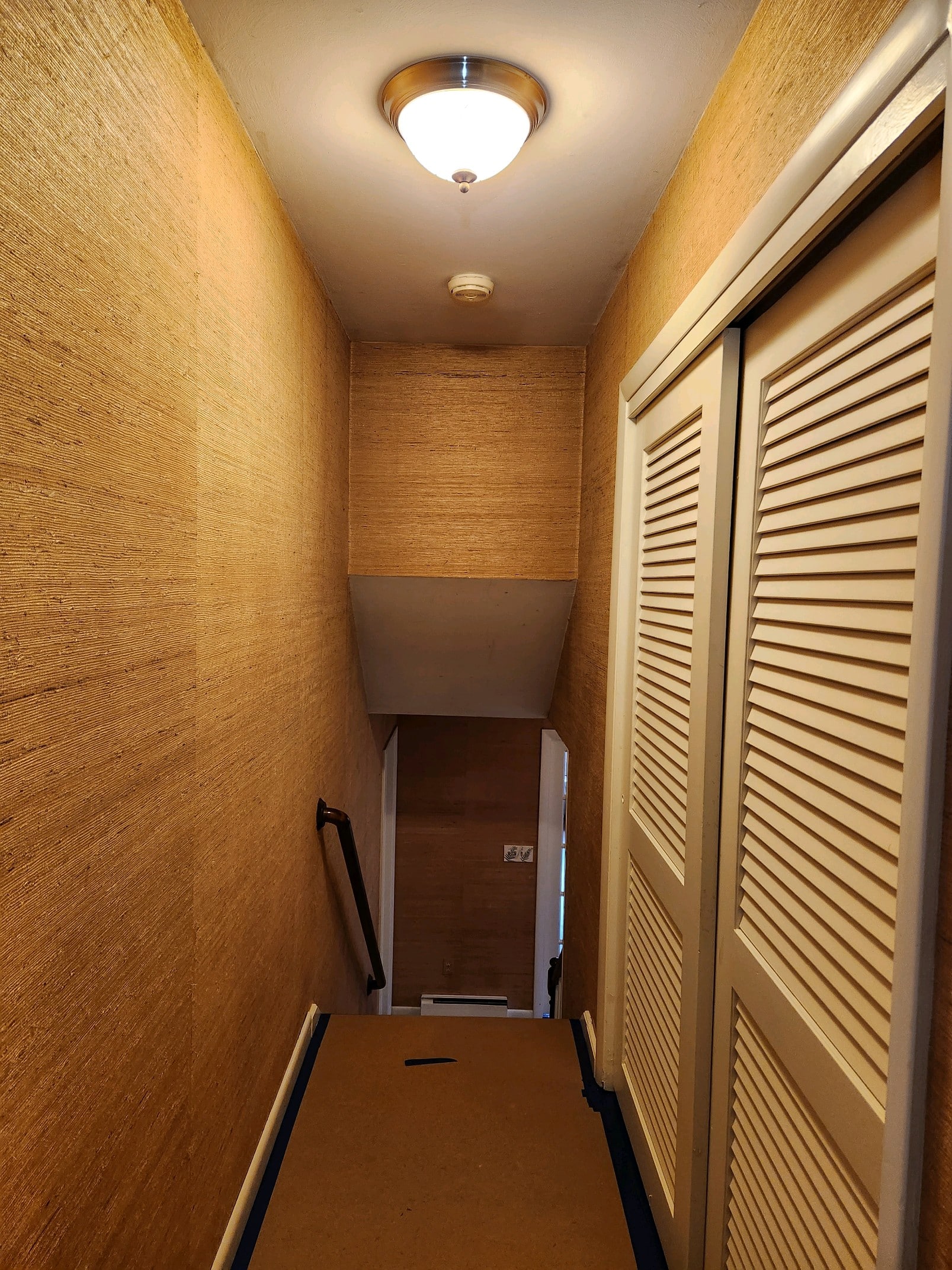 A home's hallway with a closet on the right