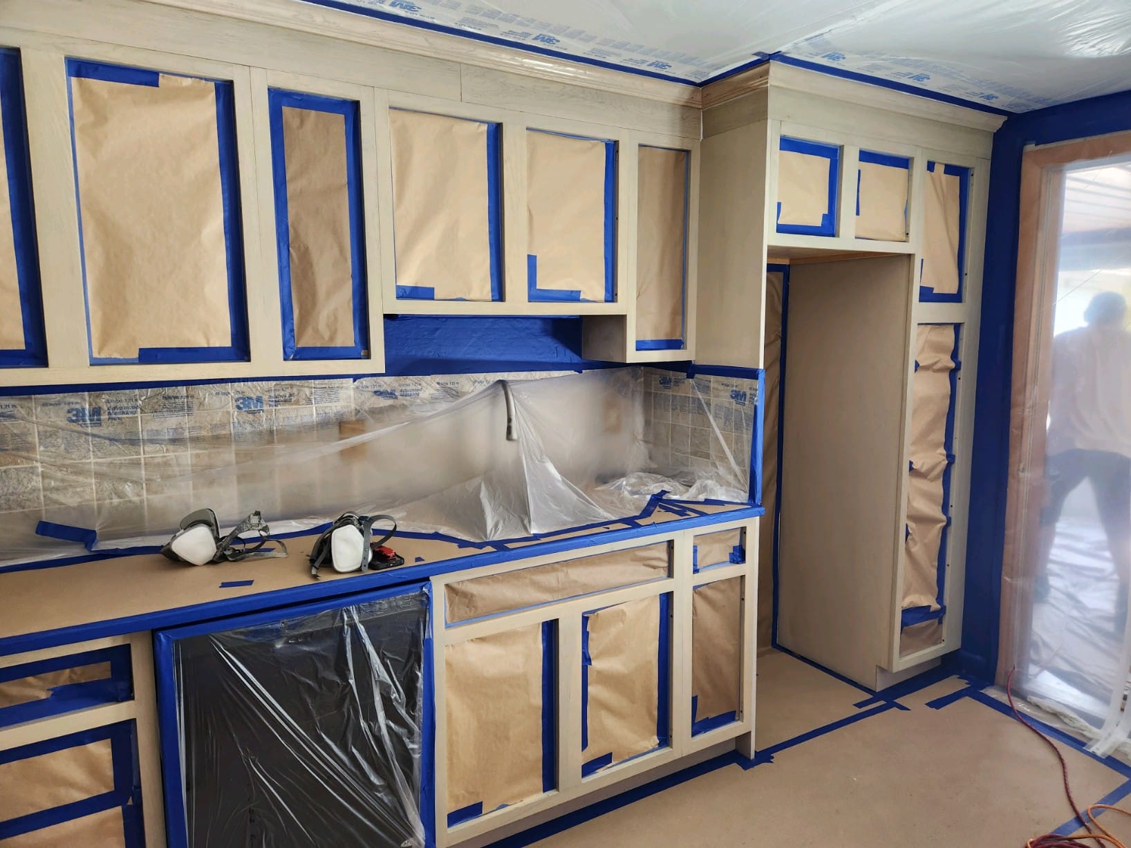 Home's kitchen cabinets being painted